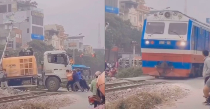 Người dân hô nhau lại cùng giải cứu tài xế và xe tải mắc kẹt trên đường ray tàu.