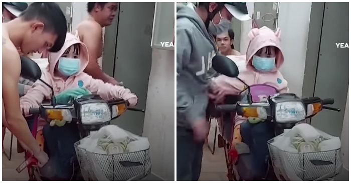 Cha cùng con gái chạy xe về quê, hũ tro cốt của mẹ để trên giỏ xe (ảnh cắt từ clip).
